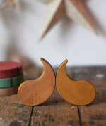 Papoose Toys wooden earth yim yam in yellow placed on a wooden desk.