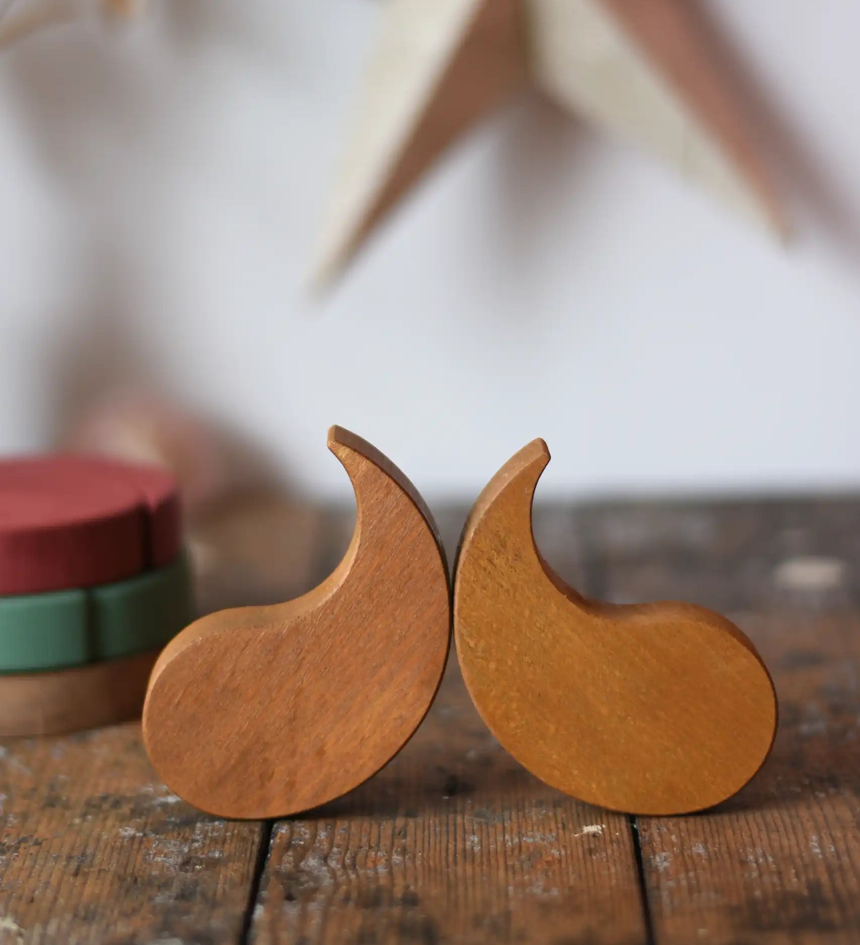 Papoose Toys wooden earth yim yam in yellow placed on a wooden desk.