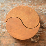 Papoose Toys wooden earth yim yam in yellow placed on a wooden desk.