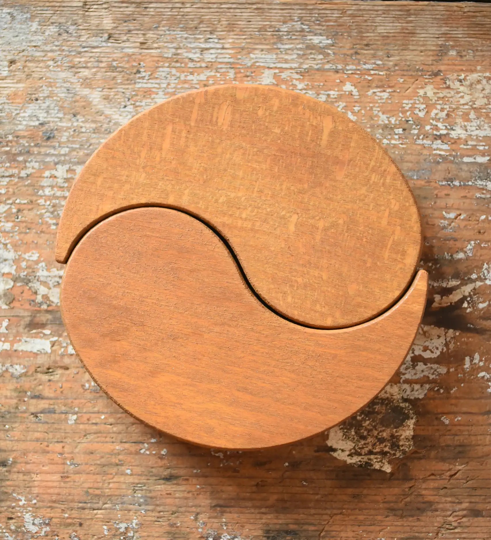 Papoose Toys wooden earth yim yam in yellow placed on a wooden desk.