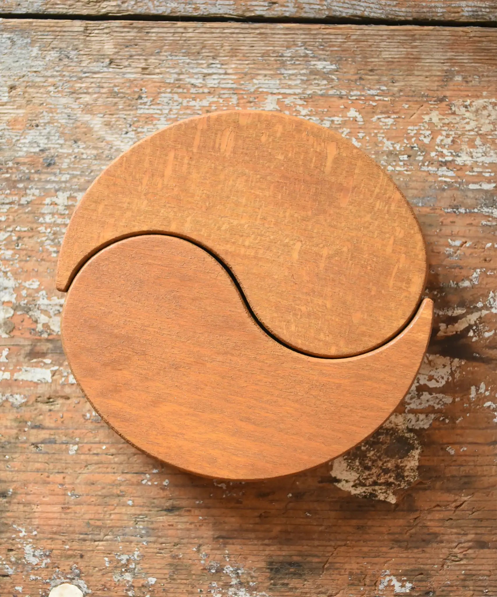 Papoose Toys wooden earth yim yam in yellow placed on a wooden desk.