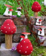 Papoose Toys felt toadstool wooden toy set used in a small world play scene with other toadstool and mushroom themed toys in the Babipur garden.