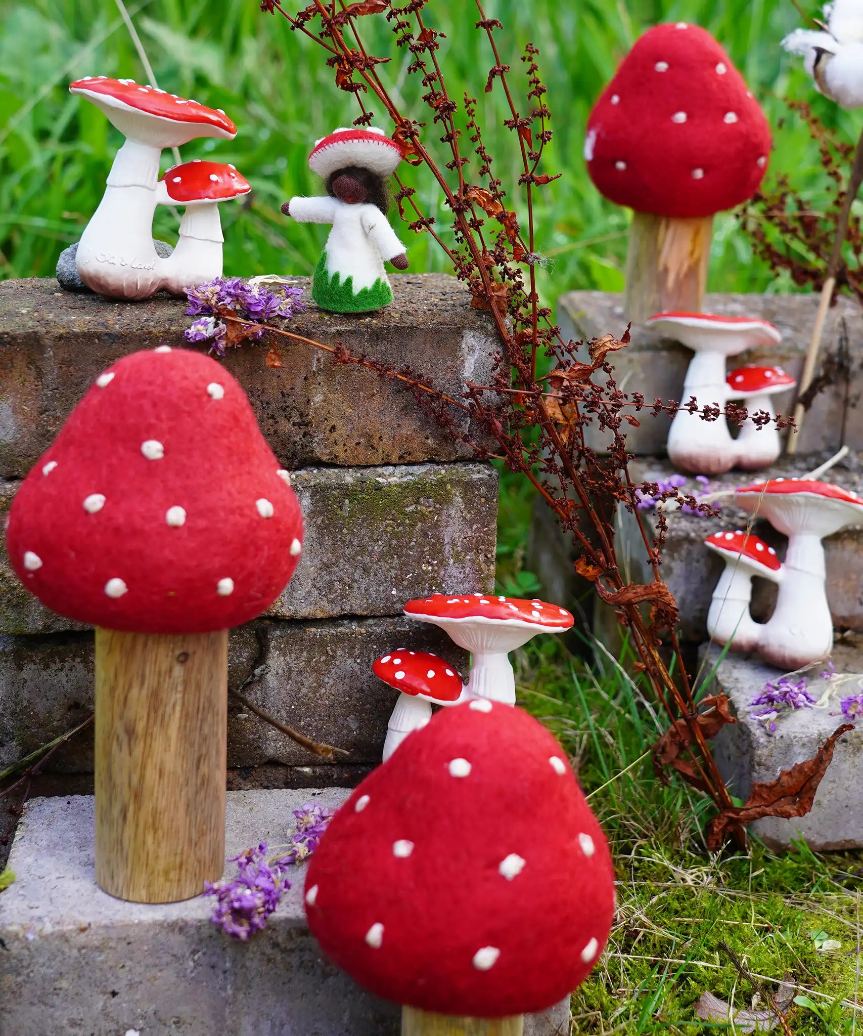 Papoose Toys felt toadstool wooden toy set used in a small world play scene with other toadstool and mushroom themed toys in the Babipur garden.