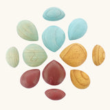 Papoose Toys earth wooden pebbles placed in a mandala shape.
