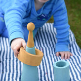 Child playing with pieces from the Papoose Toys wooden earth tinker tray school set.