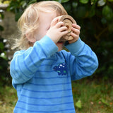 Child looking through the Papoose nesting tubes holding them up over his eyes.