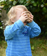 Child looking through the Papoose nesting tubes holding them up over his eyes.