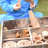 Close up of child taking out pieces from the Papoose Toys wooden tinker tray school set