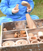 Close up of child taking out pieces from the Papoose Toys wooden tinker tray school set