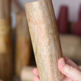 Tall Papoose Toys wooden stacking trunk in an adult's hand.