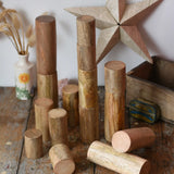 Papoose Toys wooden stacking trunks placed on a wooden desk.