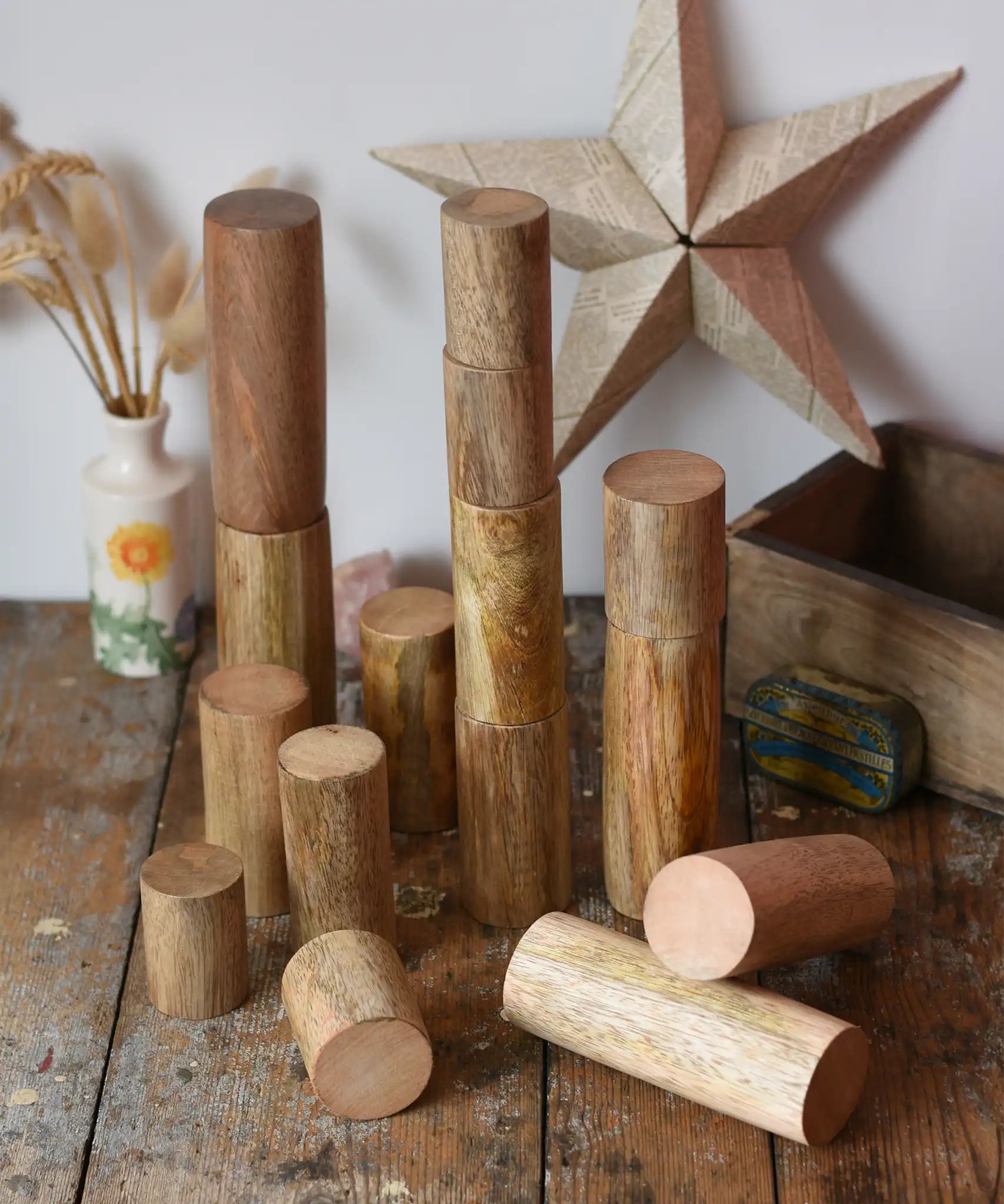 Papoose Toys wooden stacking trunks placed on a wooden desk.
