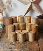 Papoose Toys wooden stacking trunks placed on a wooden desk.