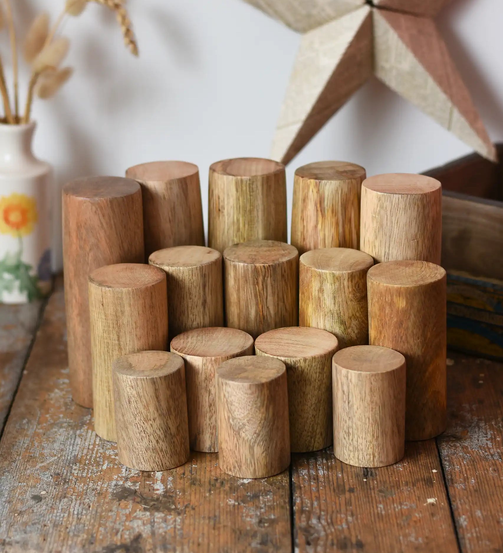 Papoose Toys wooden stacking trunks placed on a wooden desk.