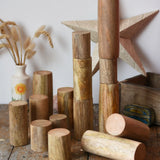 Papoose Toys wooden stacking trunks placed on a wooden desk.