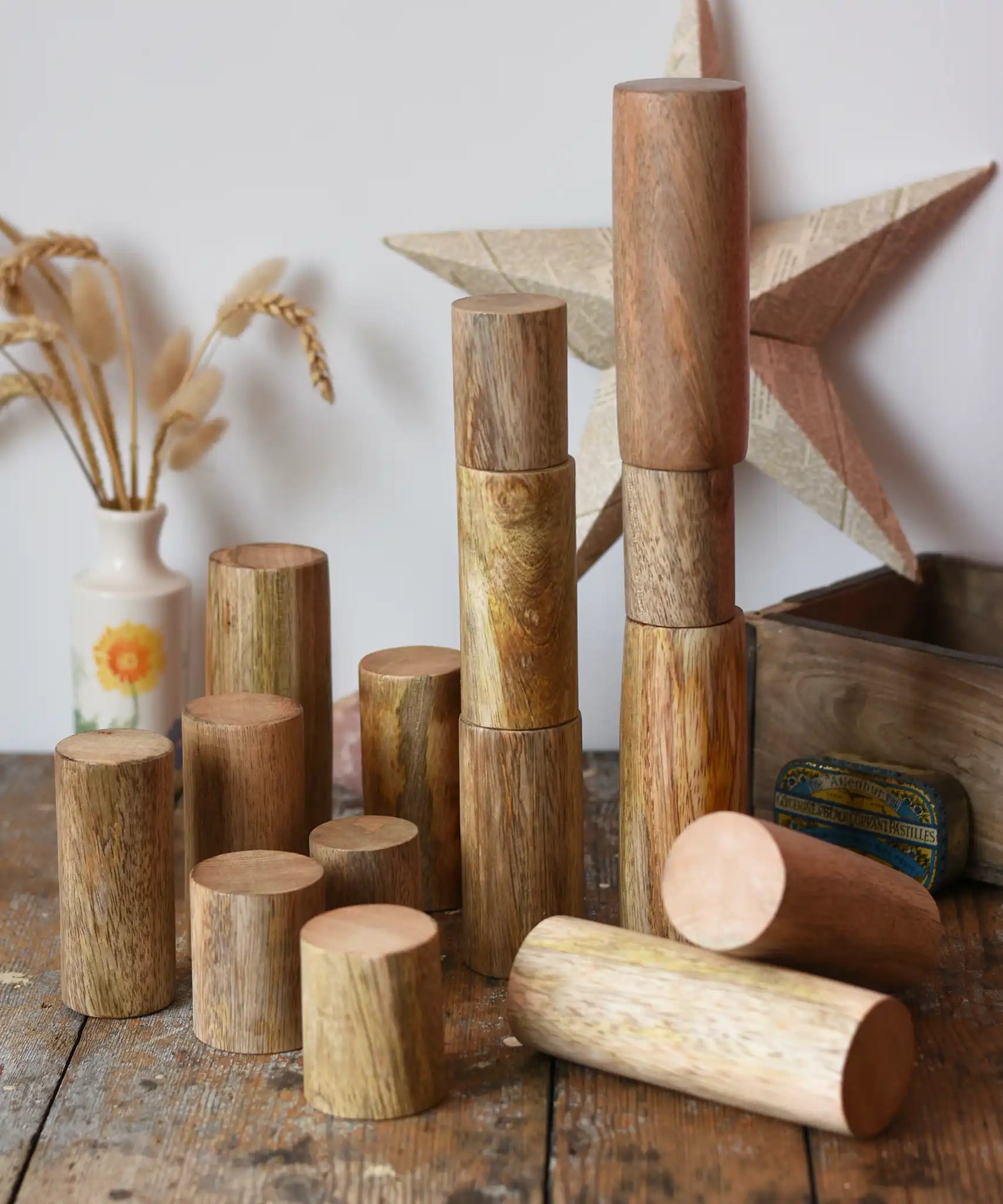 Papoose Toys wooden stacking trunks placed on a wooden desk.