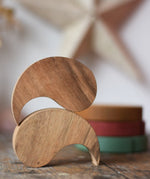 Papoose Toys wooden yim yams in natural wood placed on a wooden board.