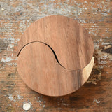 Papoose Toys wooden yim yams in natural wood placed on a wooden board.