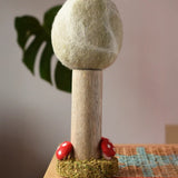 Papoose Toys Winter felt woodland tree placed on a rattan top stool. 