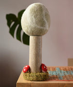 Papoose Toys Winter felt woodland tree placed on a rattan top stool. 