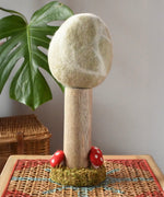 Papoose Toys Winter felt woodland tree placed on a rattan top stool. 