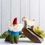 Papoose Toys Bearded Felt Tomten Gnome with a wooden bridge and goat toy in the background