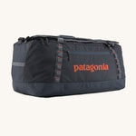 Patagonia 100 litres duffel bag in a navy blue colour on a cream background.