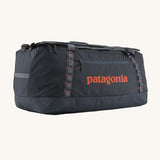 Patagonia 100 litres duffel bag in a navy blue colour on a cream background.