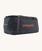 Patagonia 100 litres duffel bag in a navy blue colour on a cream background.