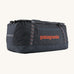 Patagonia 100 litres duffel bag in a navy blue colour on a cream background.