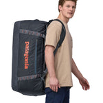 Patagonia 100 litres duffel bag in a navy blue colour carried by an adult