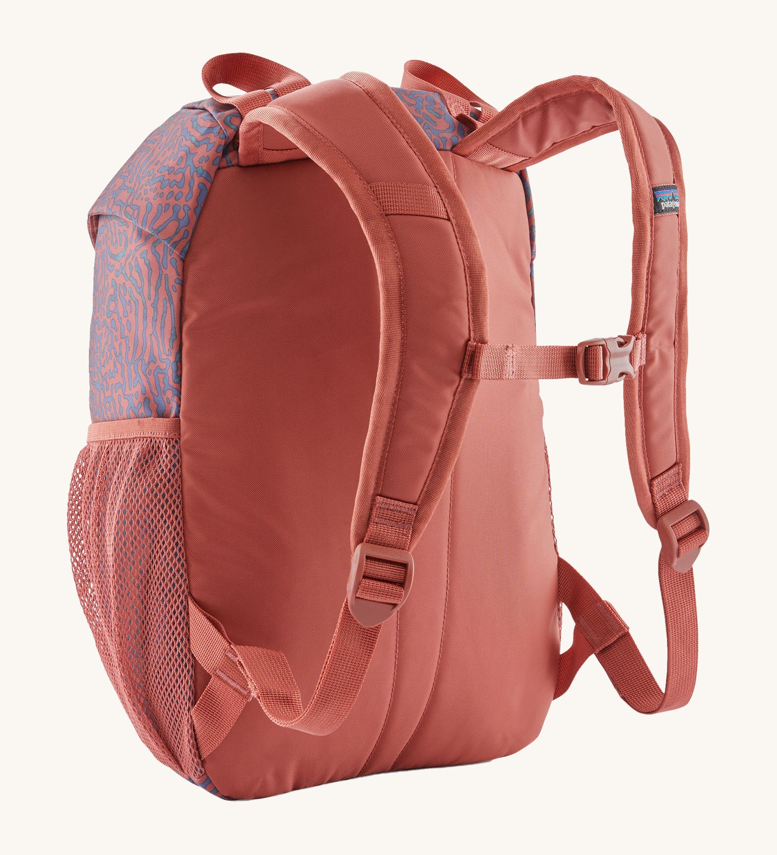 A reverse image of the The Patagonia Kids Refugito 12L Backpack  in sea run potters red showing the padded shoulder straps and matching chest straw detail