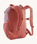 A reverse image of the The Patagonia Kids Refugito 12L Backpack  in sea run potters red showing the padded shoulder straps and matching chest straw detail