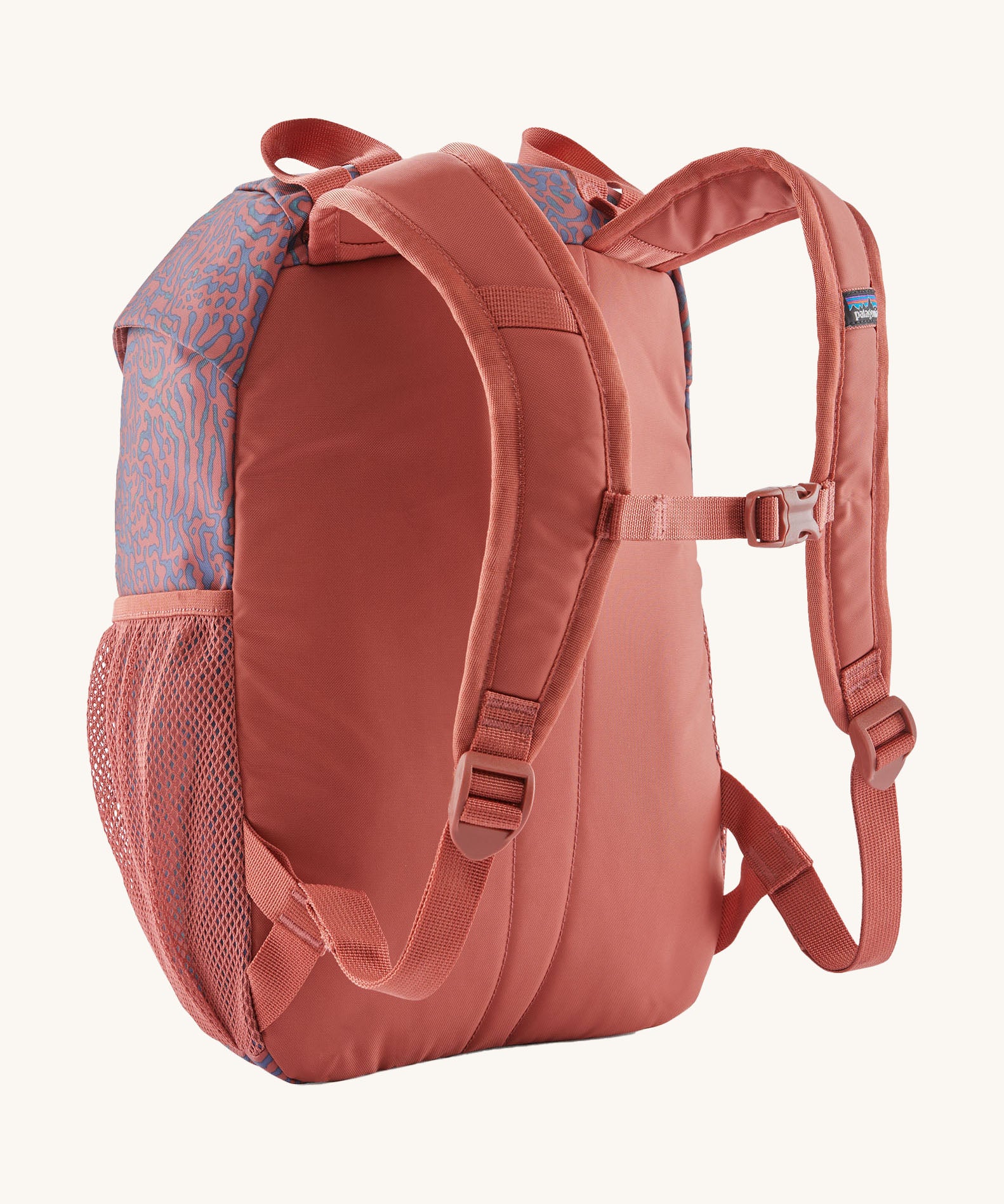 A reverse image of the The Patagonia Kids Refugito 12L Backpack  in sea run potters red showing the padded shoulder straps and matching chest straw detail