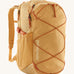 Patagonia 30L yellow refugio day backpack with a flower design on a cream background.