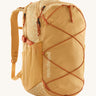 Patagonia 30L yellow refugio day backpack with a flower design on a cream background.