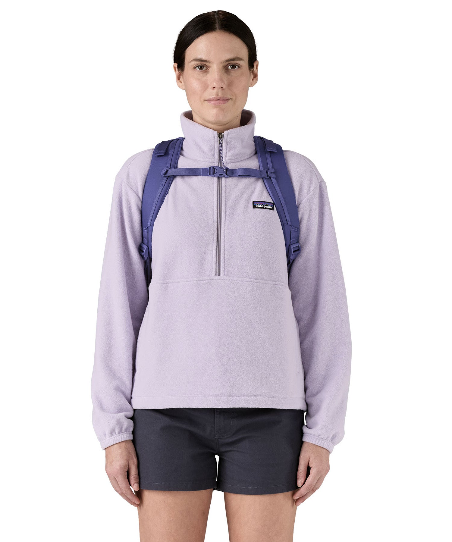 Patagonia 30L purple refugio day backpack worn by an adult shoulder strap and clip detail