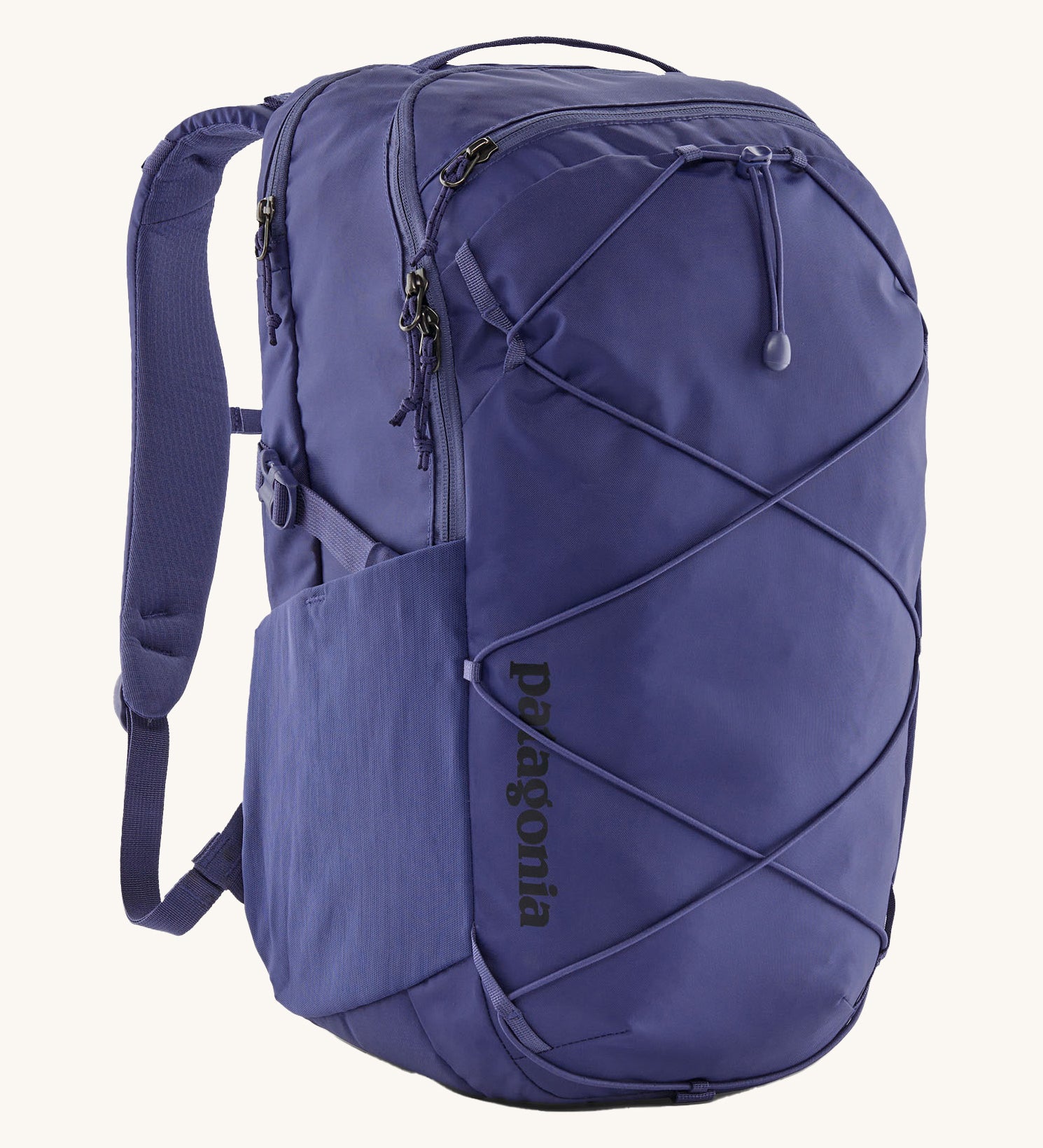 Patagonia 30L purple refugio day backpack on a cream background.