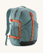 Patagonia 30L refugio backpack in blue sage with side bottle holder and orange gear loops and quick release buckles.
