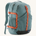 Patagonia 30L refugio backpack in blue sage with side bottle holder and orange gear loops and quick release buckles.