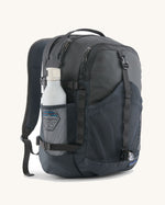 Patagonia 30L refugio backpack in smolder blue with side bottle holder and black gear loops and quick release buckles.