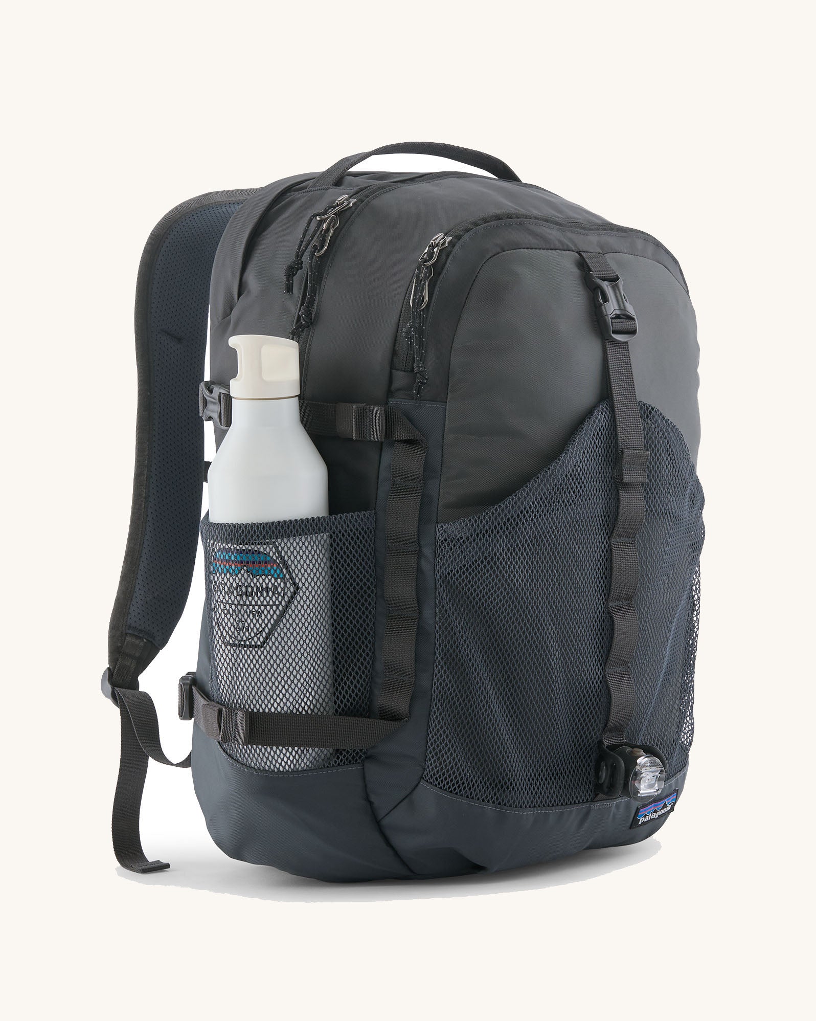 Patagonia 30L refugio backpack in smolder blue with side bottle holder and black gear loops and quick release buckles.