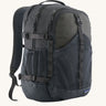 Patagonia 30L refugio backpack in smolder blue with side bottle holder and black gear loops and quick release buckles.