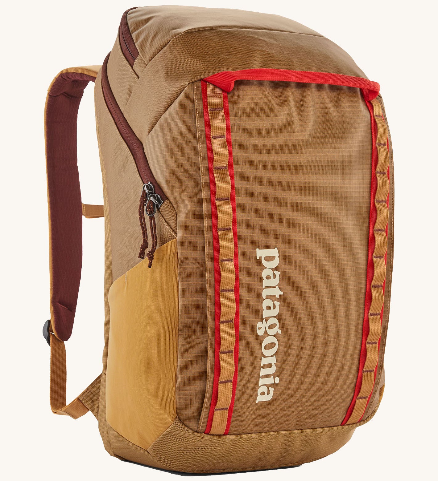 Patagonia 32L black hole packpack in talon gold. A 100% recycled polyester backpack in dark yellow and maroon detail. Features padded shoulder, side pockets for holding bottles and 2 compartments with cream branding on the front