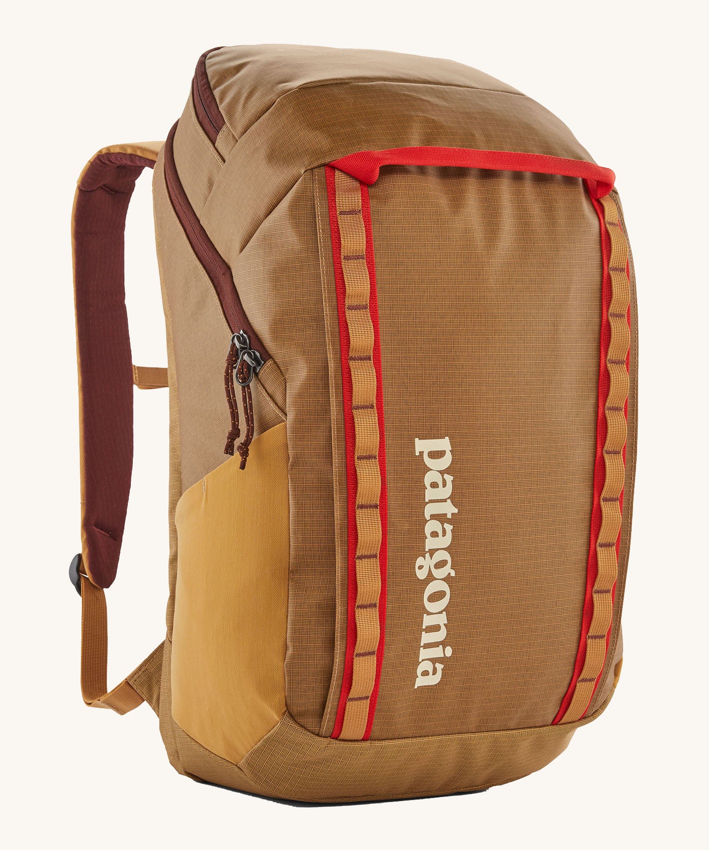 Patagonia 32L black hole packpack in talon gold. A 100% recycled polyester backpack in dark yellow and maroon detail. Features padded shoulder, side pockets for holding bottles and 2 compartments with cream branding on the front