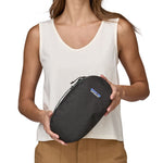 patagonia 3l travel cube held by hand showing the handle
