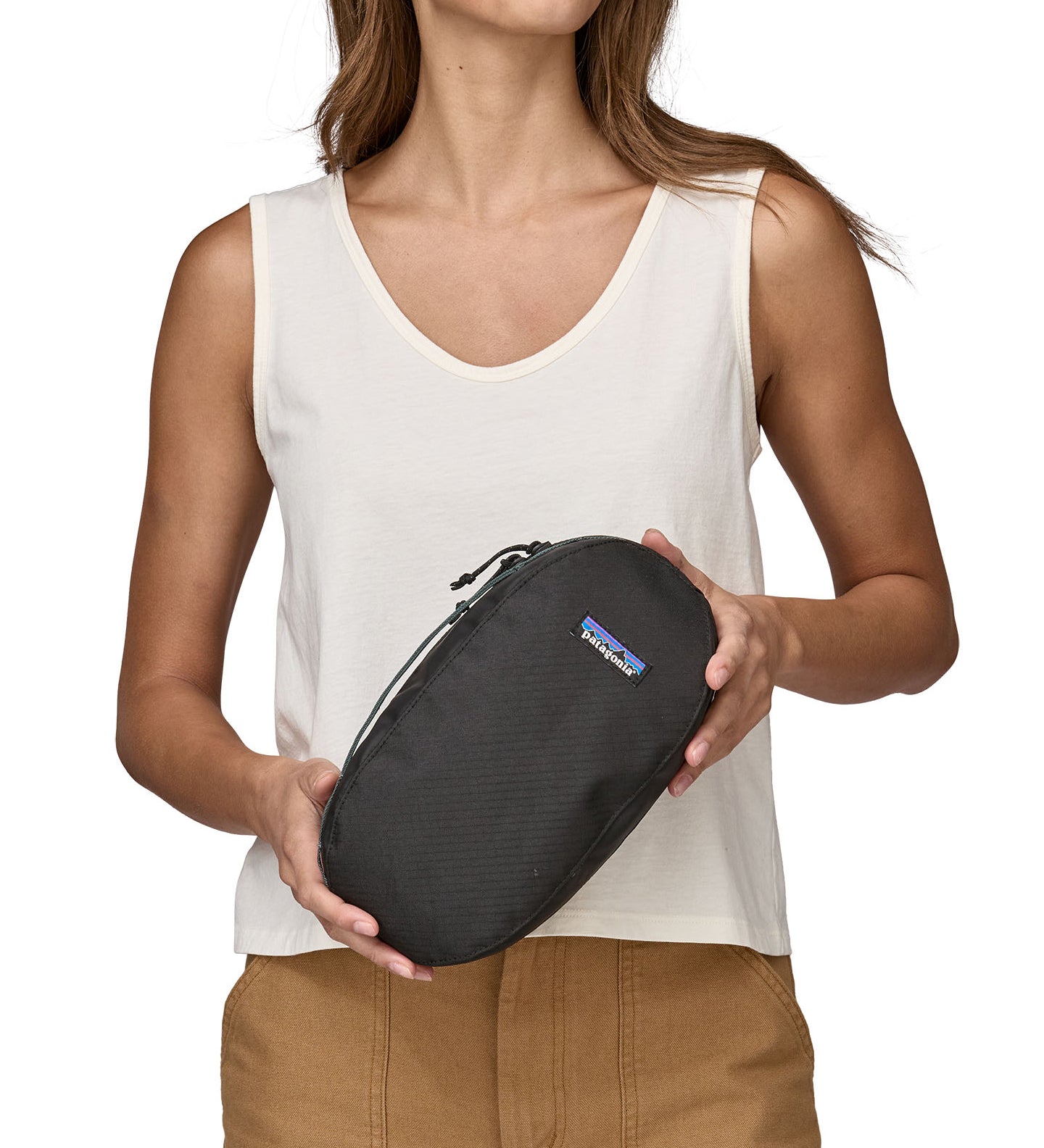 patagonia 3l travel cube held by hand showing the handle
