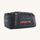 Patagonia 40 litres duffel bag in a dark navy blue colour on a cream background.