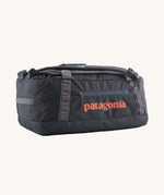 Patagonia 40 litres duffel bag in a dark navy blue colour on a cream background.