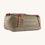 Patagonia 55 litres duffel bag in a seabird grey colour on a cream background.